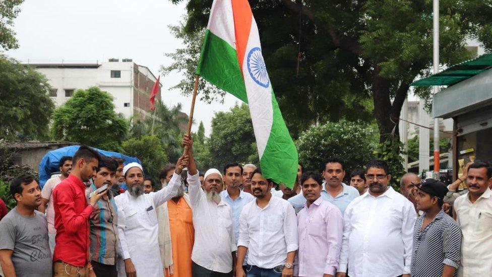 Ambedkar Vichar Manch activist celebrating with drums and flags.