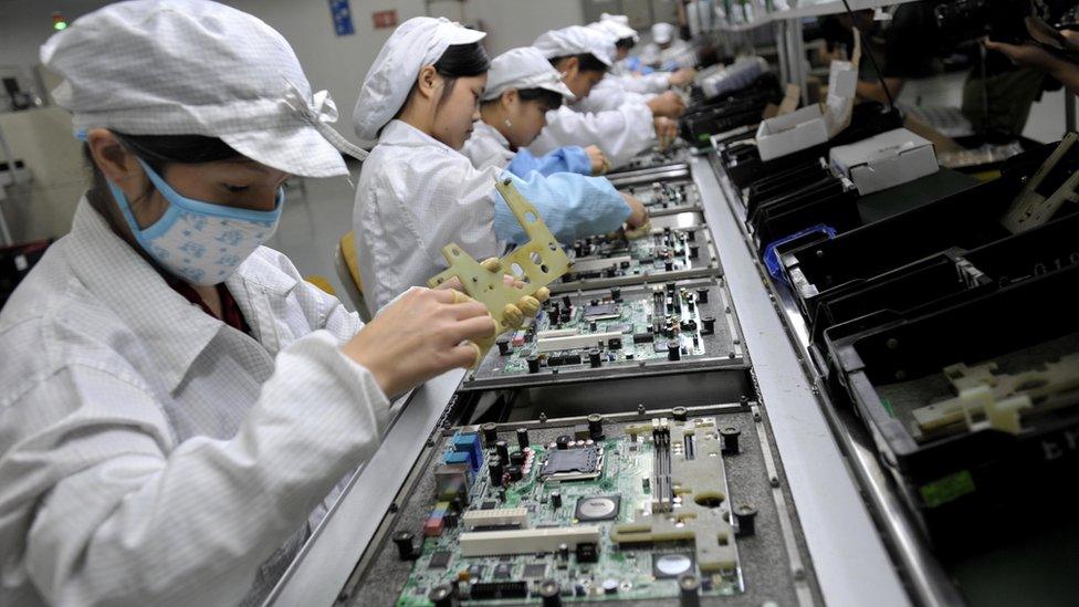 Chinese workers assemble electronic components at the Taiwanese technology giant Foxconn's factory in Shenzhen