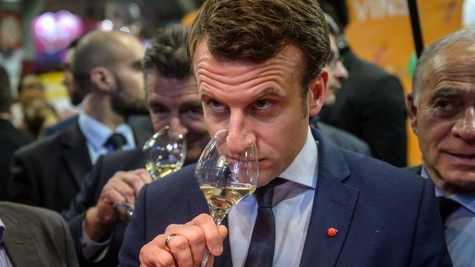 Emmanuel Macron (centre) samples wine at the agriculture fair in Paris. Photo: 1 March 2017