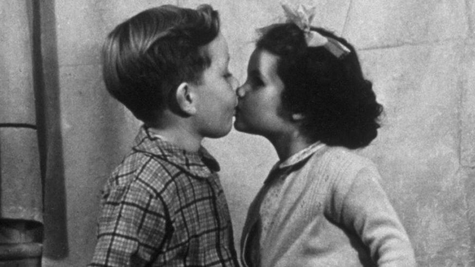 Two children kiss, 1947