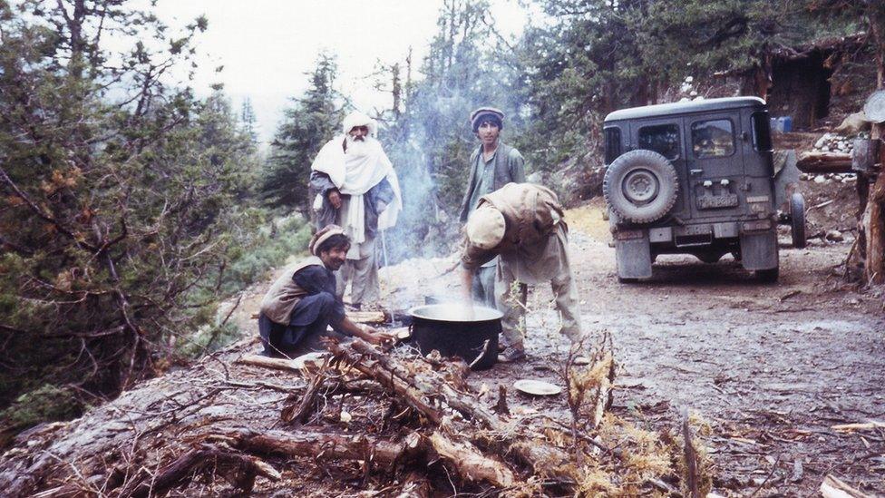 Men cooking over a fire