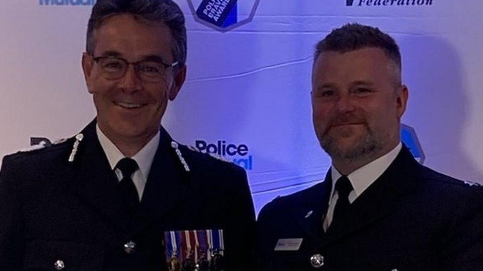 Image of two police officers at awards ceremony