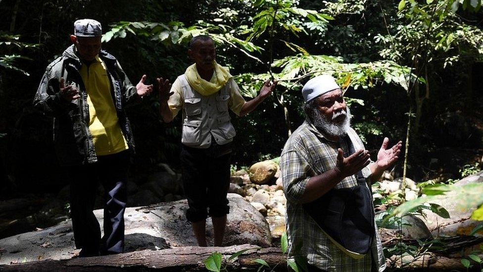 Shamans, known in Malaysia as bomoh, pray during the search effort