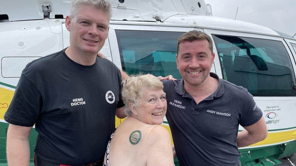 Sue Wilkinson with paramedic Andy Mawson and doctor Phil Godfrey from GNAAS