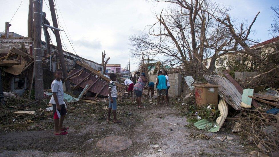 People clear wreckage in a street in Marigot on the French Caribbean island of Saint-Martin. 7 Sept 2017