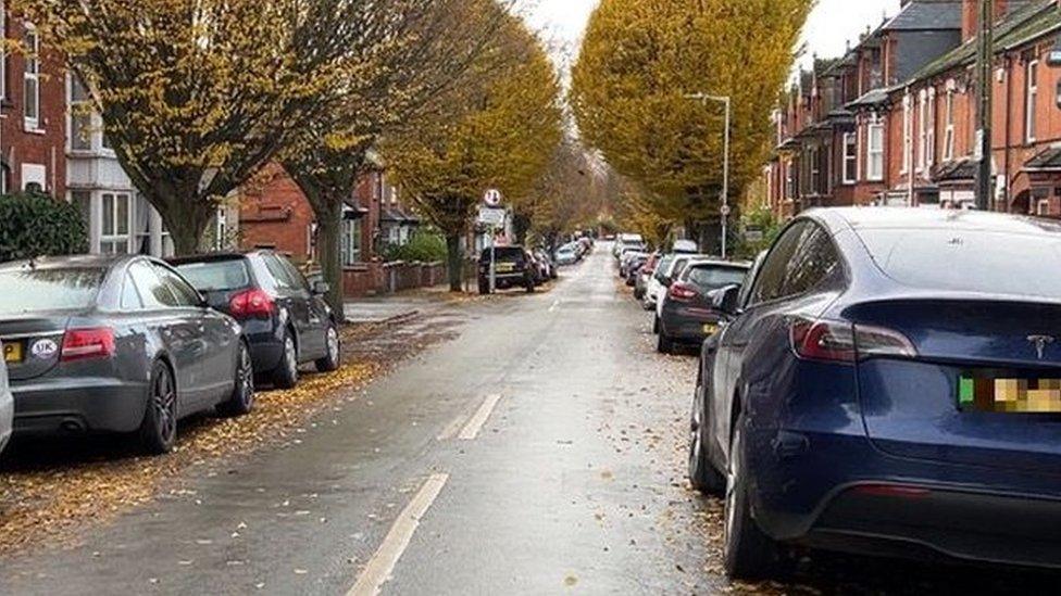 Road with cars parked on it