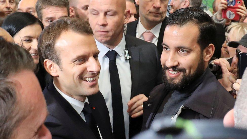 A smiling President Macron is pictured next to a smiling Mr Benalla at a public event in a crowd