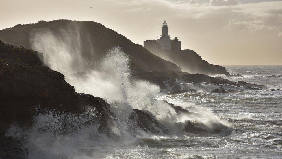 Waves crash on to the rocks at Mumbles Head on the coast