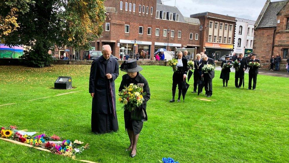 Lord-Lieutenant of Cumbria laying flowers