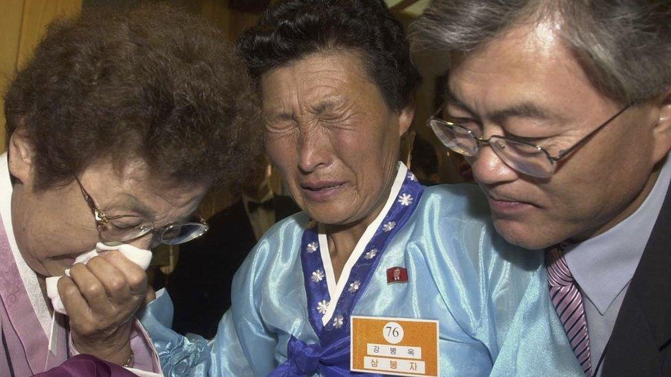 Moon Jae-In (R), a senior aide to South Korean President Roh Moo-Hyun, and his mother (L) are engaged in a tearful reunion with Moon's aunt (C) from North Korea