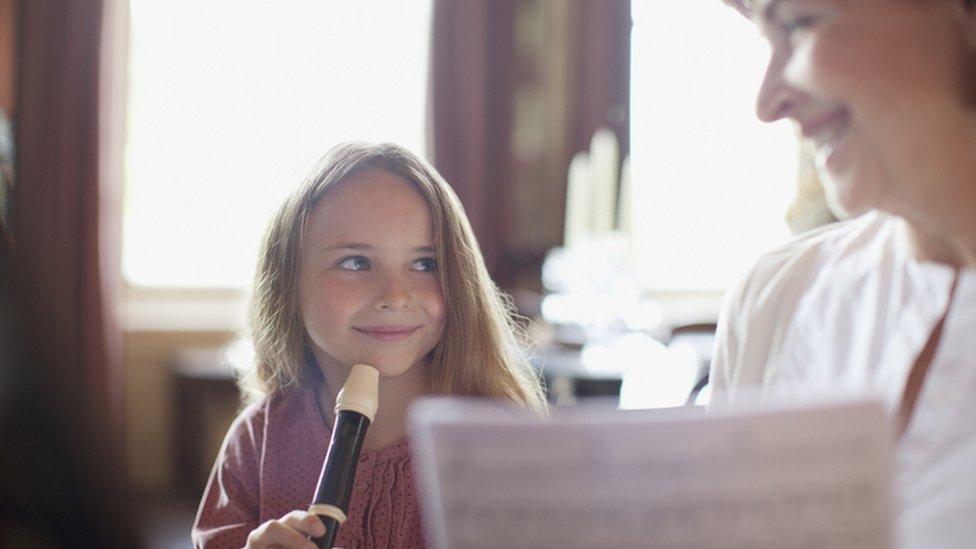 girl learning recorder