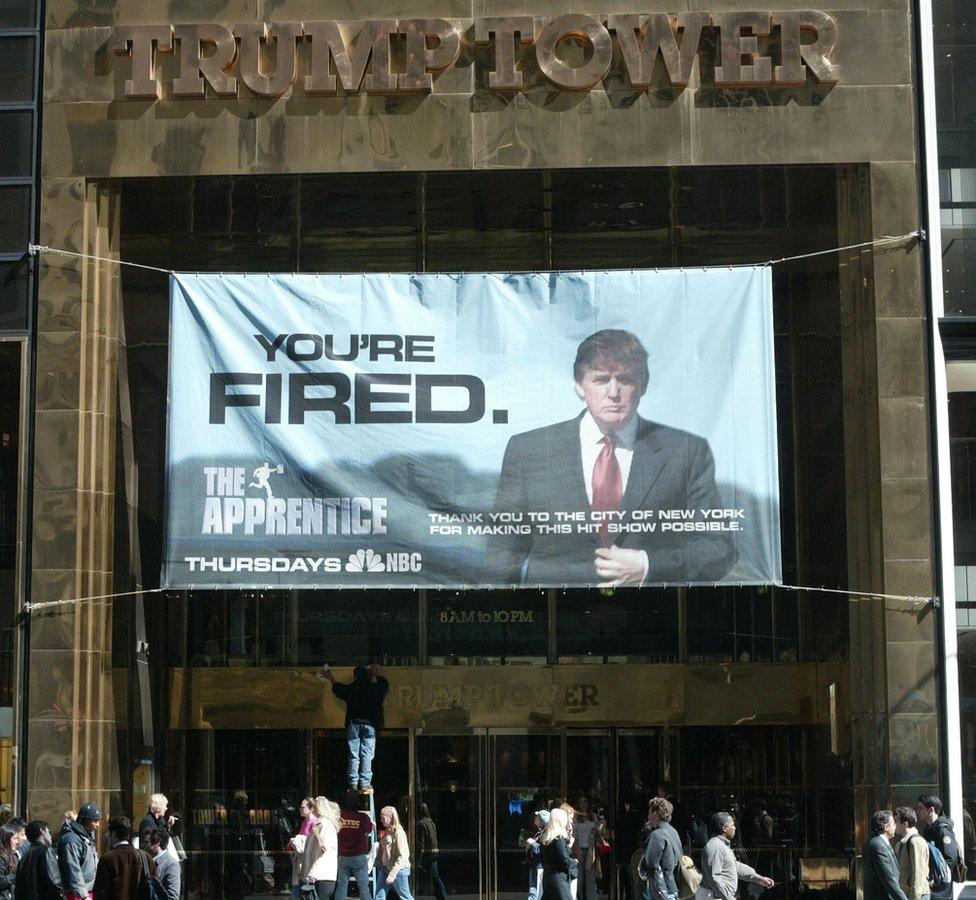 A sign with the slogan YOU'RE FIRED advertising the American television show "The Apprentice" starring Donald Trump hangs at Trump Towers April 15, 2004 in New York City.