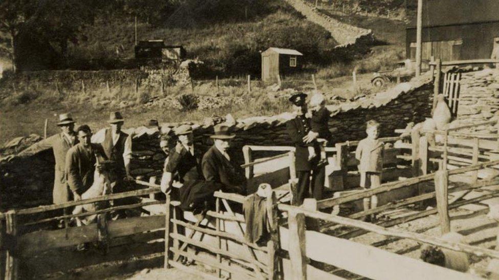 Post shed in the background of a photo from the 1940's