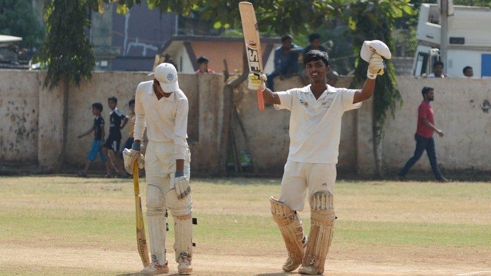 Pranav Dhanawade celebrates with a team mate during a record innings