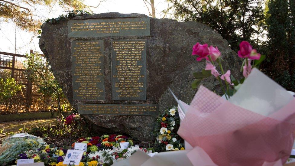 Flowers surround a memorial near St Andrew's Church