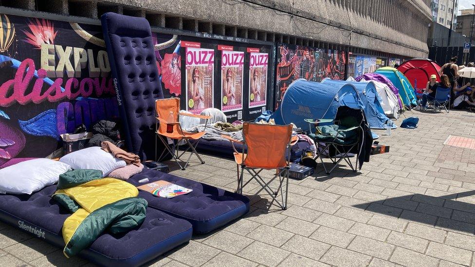 Air beds, chairs and tent line Westgate street