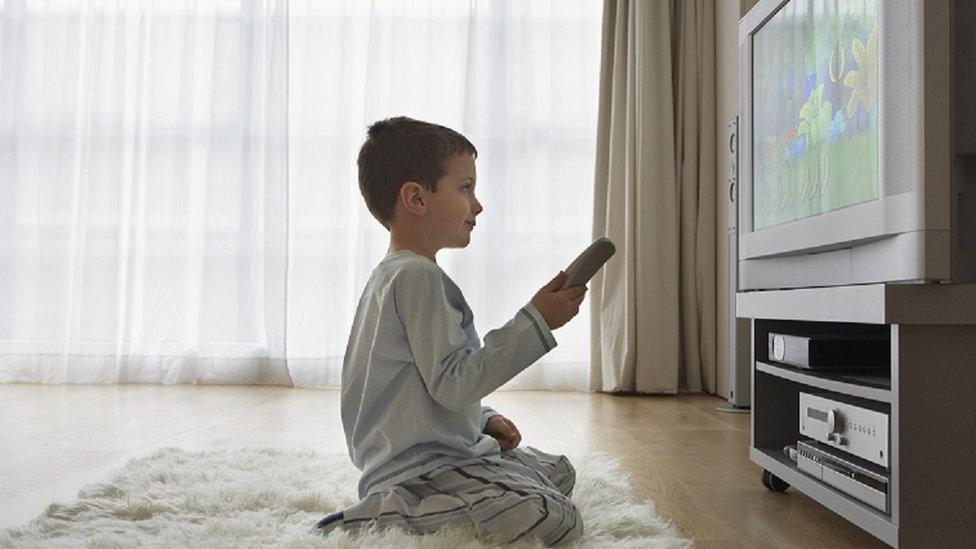 Boy watching TV close up