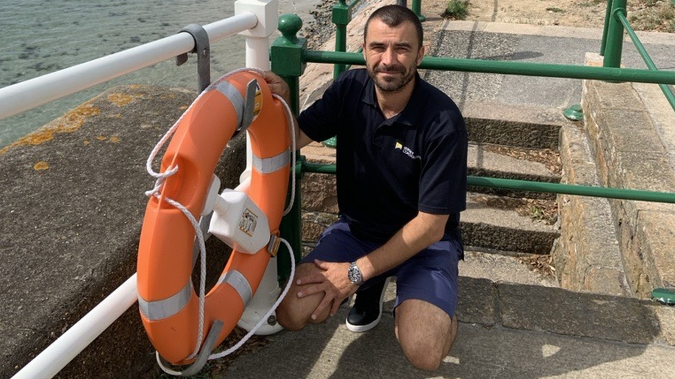 Coastguard with lifebuoy