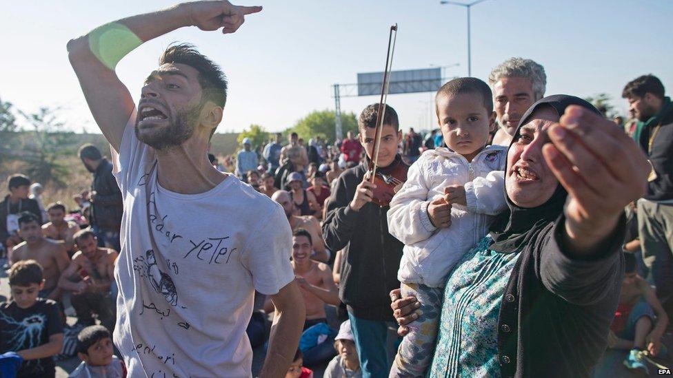 Syrian refugees shout at Turkish riot police at the Istanbul-Edirne highway as they wait for permission to pass the Turkish-Greek border in Edirne, Turkey, 19 September 2015