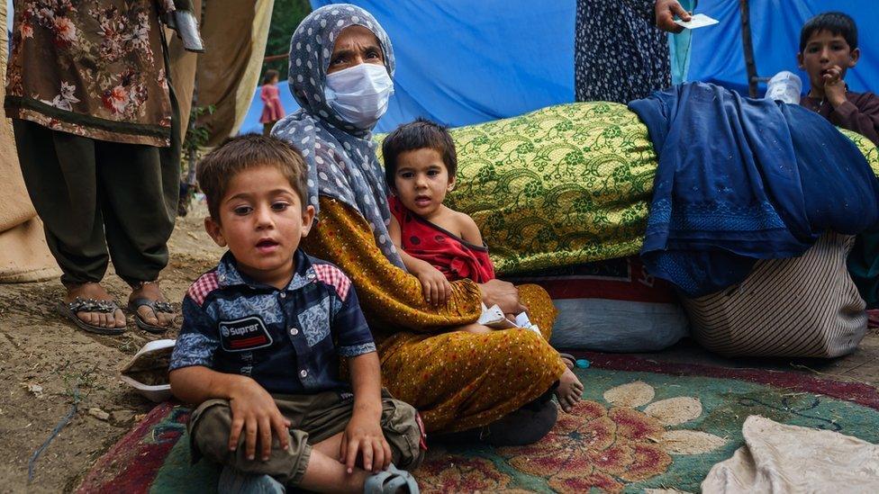 A mother and her two children who have left their home in Kabul