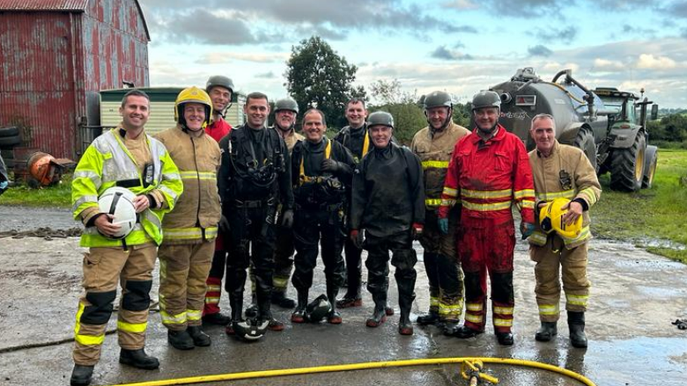 Commander John Holmes and colleagues