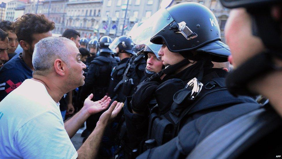 Migrants plead with police officers outside Keleti station in Budapest. 2 Sept 2015