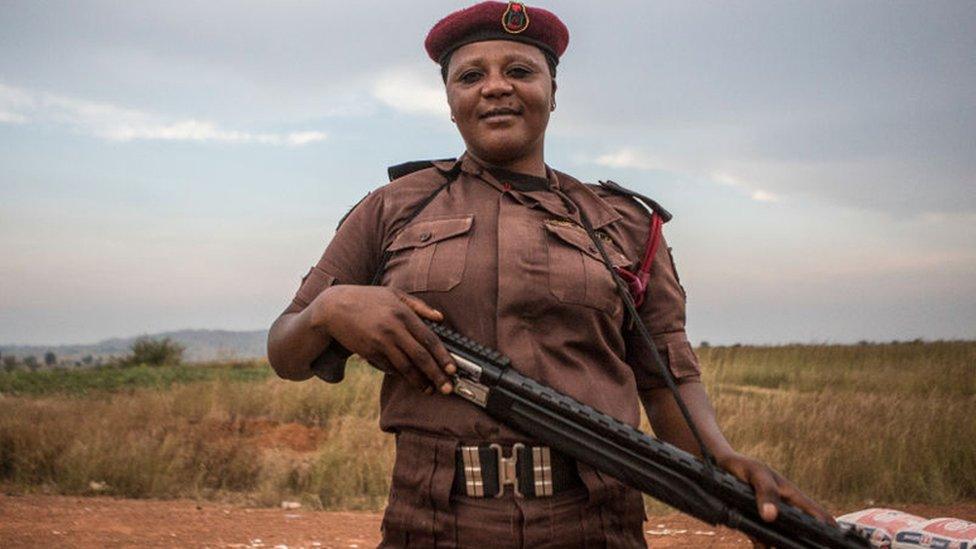 Vigilante Group of Nigeria, Barkin Ladi Division member Sarah Dung, 39, guards a check point in Barkin Ladi, Nigeria on Wednesday, October 24, 2018.