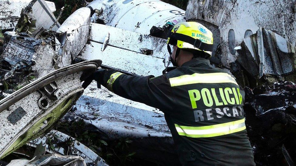 A rescue policeman works at the site of a chartered airplane crash in La Union, a mountainous area outside Medellin, Colombia, Tuesday, Nov. 29, 2016.