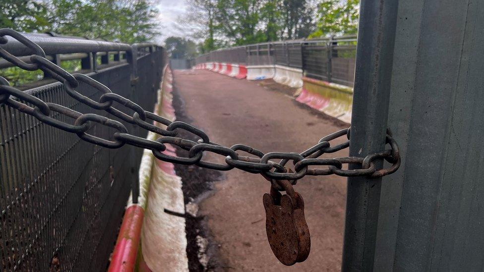 A padlock at the entrance to the cemetery