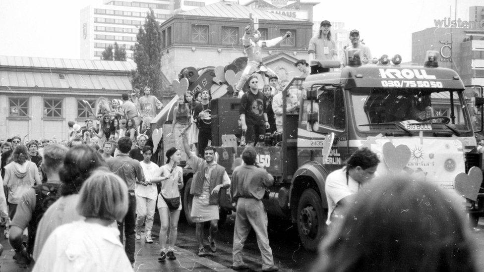 Festival-goers party in the streets of Berlin and on top of a truck at Love Parade 1992