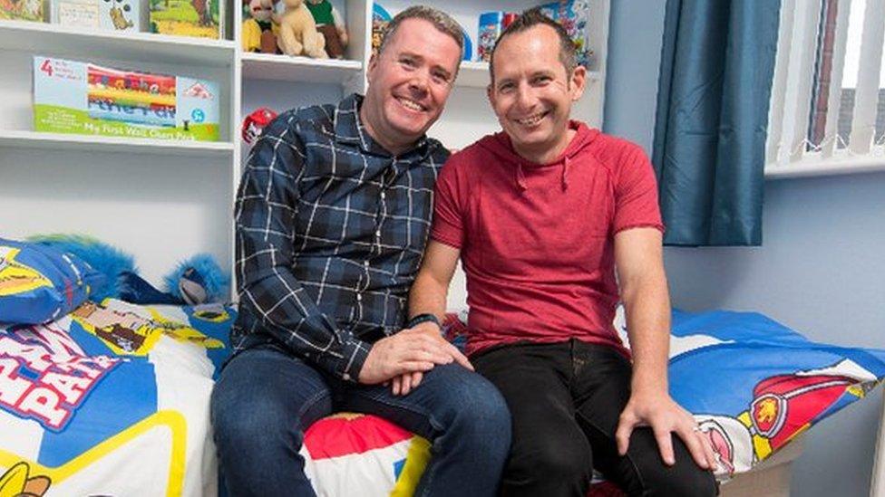 Mike and Tony in a bedroom decorated for a young boy