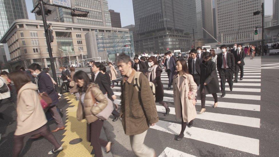 Japanese office workers crossing the road