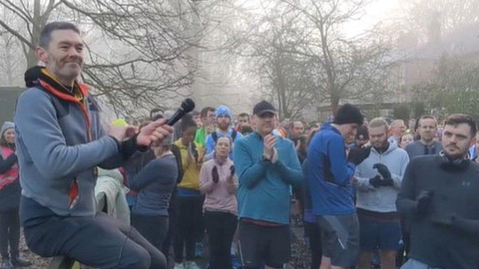 Parkrun runners applauding Arthur Walsham at the start of the race