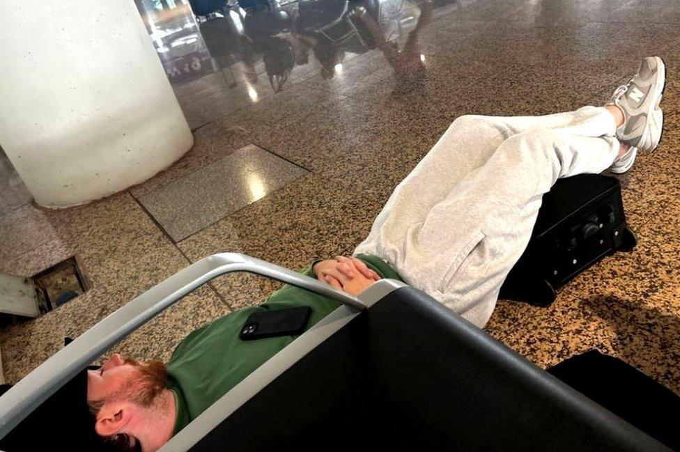 Scott Coyle sleeping on the airport floor