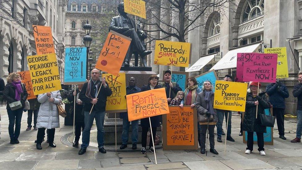 Protesters holding placards