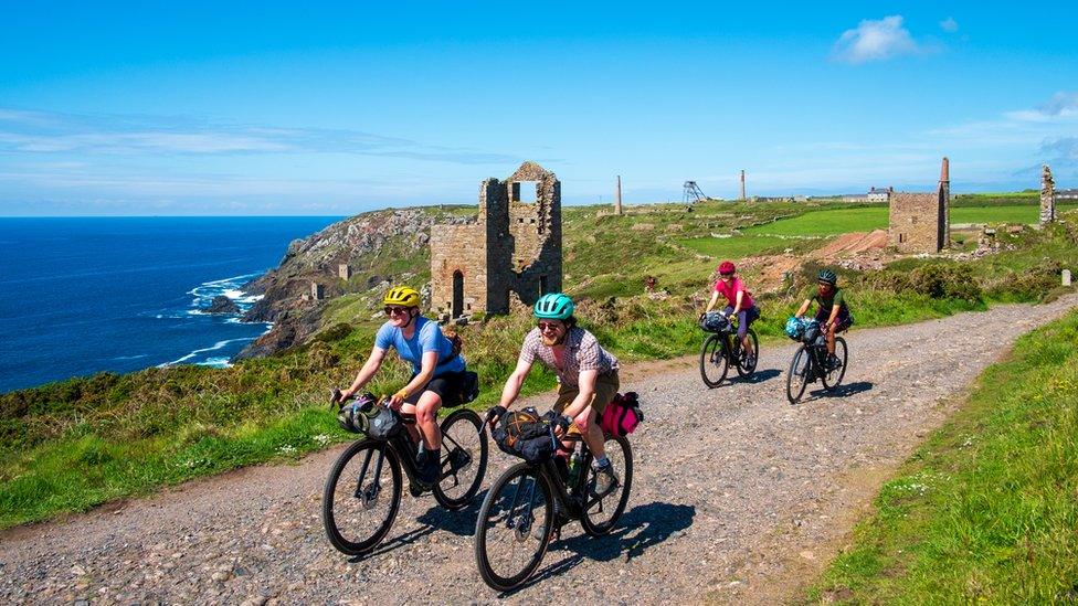 Cyclists riding along the West Cornwall coast