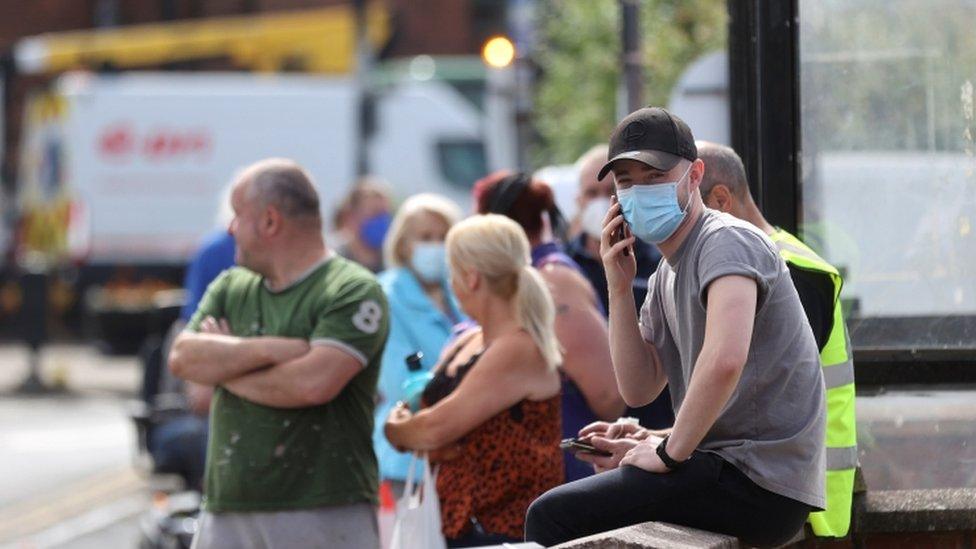 People wait in line at a testing centre