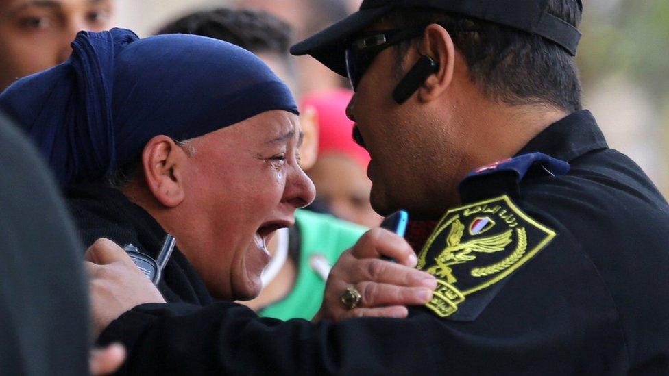 A relative of one of the blast victims screams at a police officer in front of St. Mark"s Coptic Orthodox Cathedral after an explosion inside the cathedral in Cairo