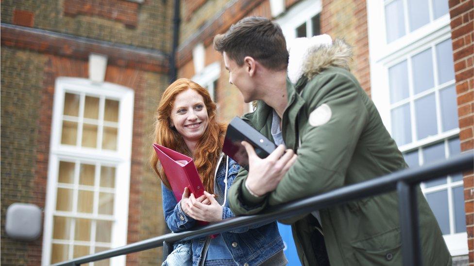 Students talking outside a university building