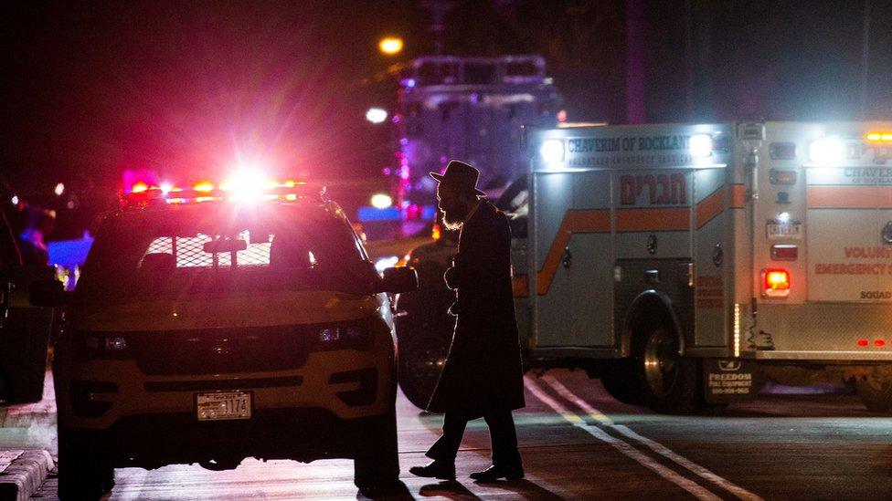 A Jewish man walks near the area where 5 people were stabbed at a Hasidic rabbi"s home in Monsey