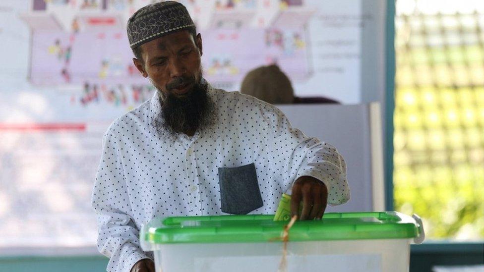 Rohingya Muslim man votes at a polling station in a refugee camp outside Sittwe