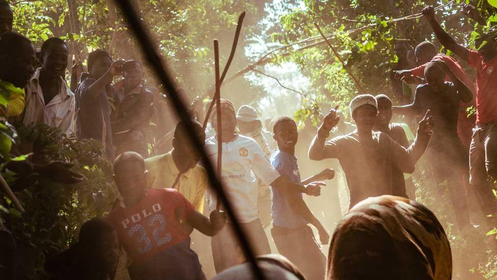 People cheering on bulls during a fight in western Kenya