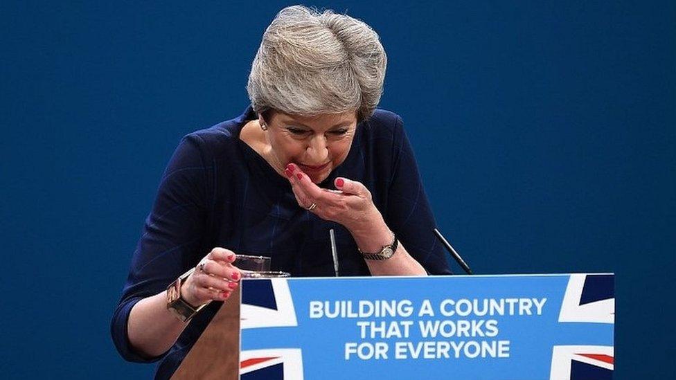 Theresa May struggles as she takes a drink of water during her conference speech