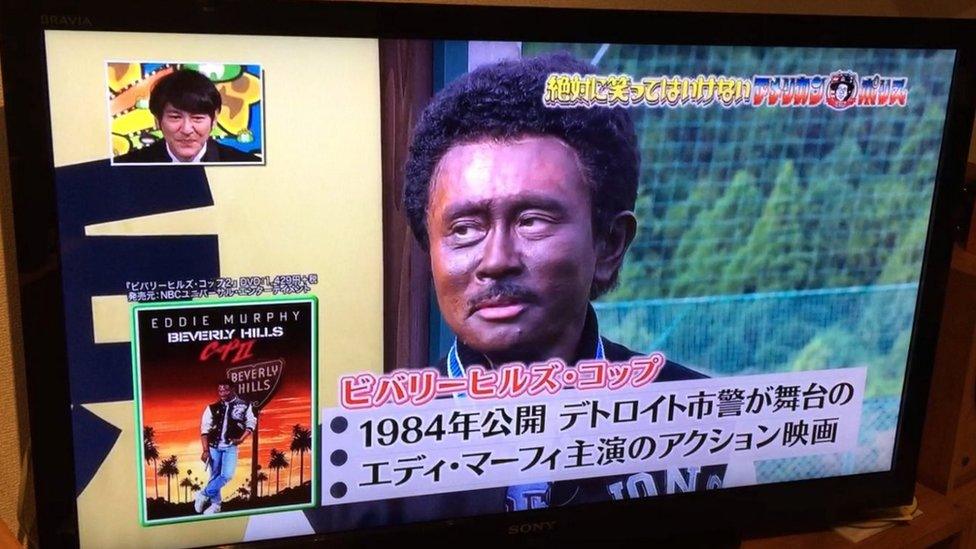 Japanese comedian with his face painted black