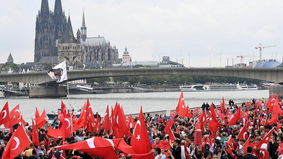 Supporters of Turkish President Recep Tayyip Erdogan rally at a gathering on July 31, 2016 in Cologne, Germany