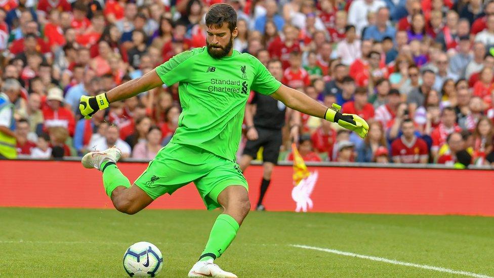 Alisson takes a goal kick