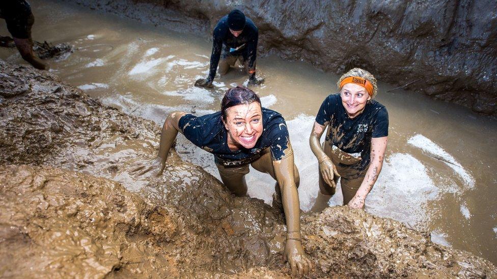 Participants emerging from the mud