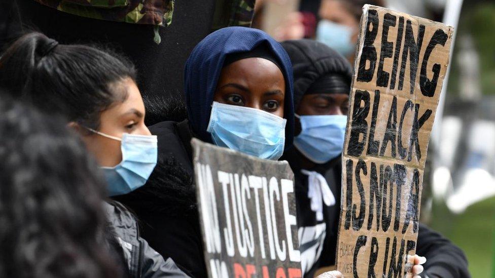 protestors-with-signs-in-Manchester.