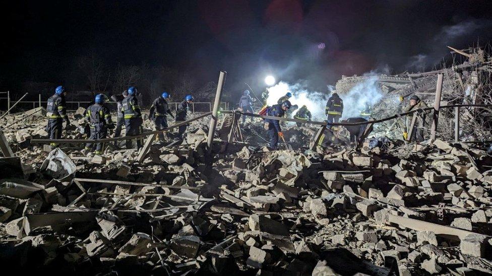 Rescuers work at the site of a Russian missile strike in Pokrovsk