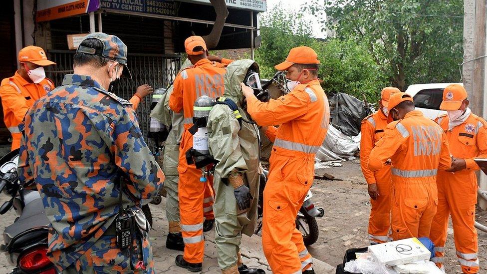 Members of National Disaster Response Force (NDRF) wear protective gear at the site of a gas leak in Ludhiana, 30 April